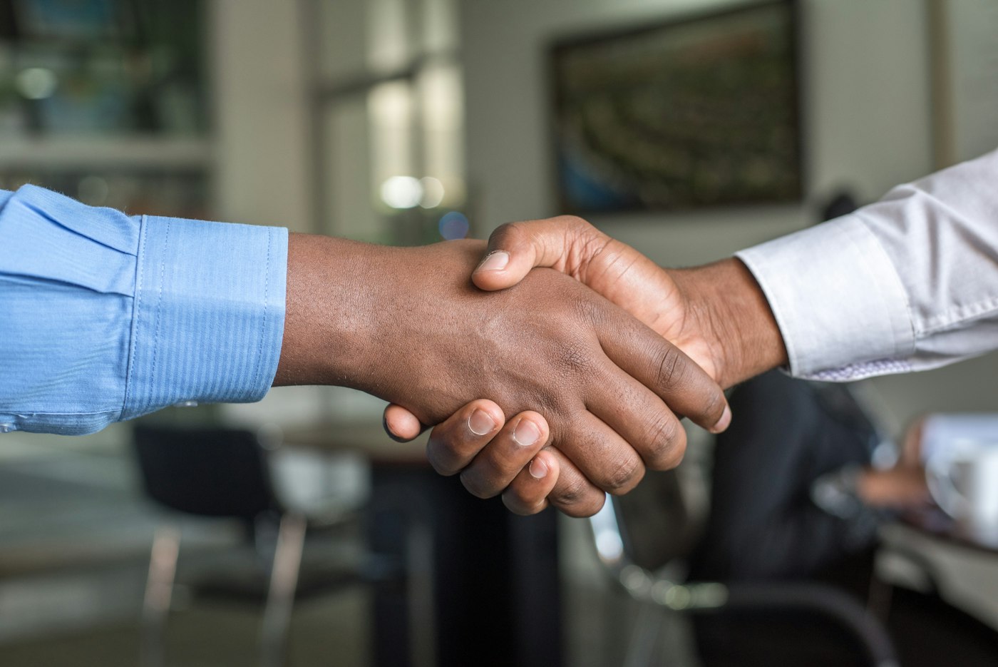 Two people shaking hands — people at the center of Jakelo's mission
